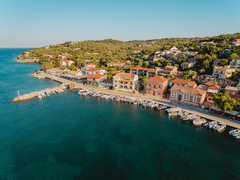 High angle view of gaios townscape by sea against clear sky in greece.