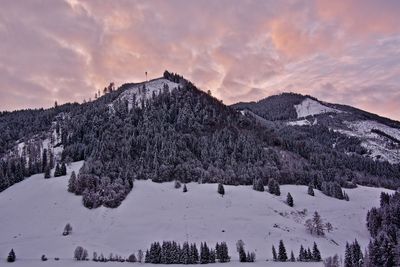 Scenic view of snowcapped mountains against sky during sunset