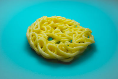 High angle view of yellow pepper against blue background