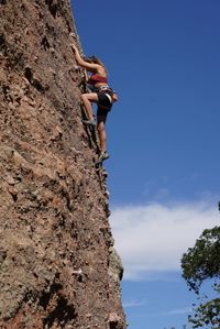 Low angle view of man standing on rock