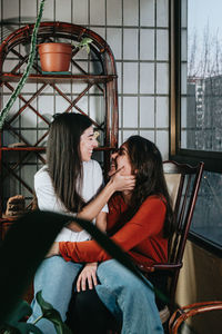 Lesbian women embracing at home