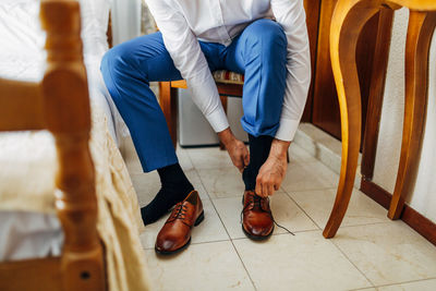 Low section of people sitting on chair