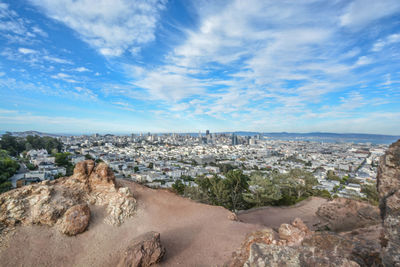 Cityscape against cloudy sky