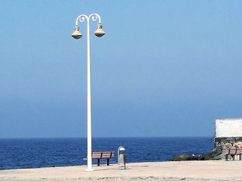 Lifeguard hut on beach against clear sky