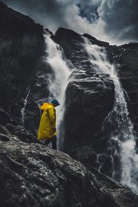 Side view of man by waterfall