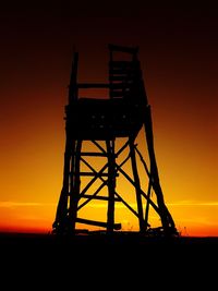 Silhouette built structure against sky during sunset