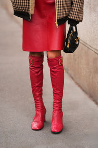 Low section of woman standing on street