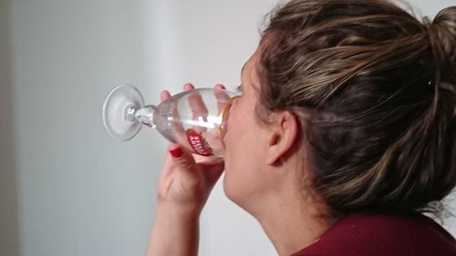 Close-up portrait of a woman drinking glass