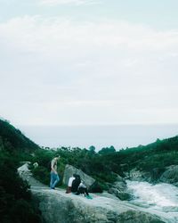 People standing on beach against sky