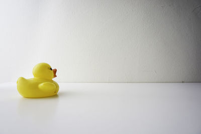 Close-up of yellow toy against white background