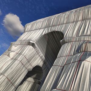 Low angle view of building against cloudy sky