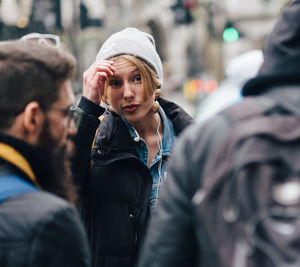 Portrait of young man with hat in city