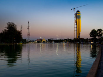 Reflection of buildings in lake at sunset