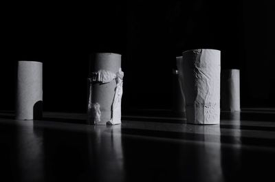 Close-up of empty tissue rolls against black background