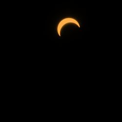 Low angle view of silhouette moon against sky at night