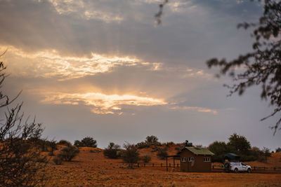Scenic view of field against sky during sunset