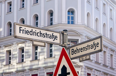 Streetname signs at the junction of friedrichstrasse and behrenstrasse in mitte district