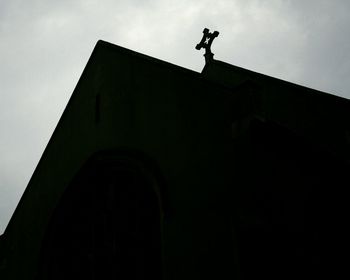 Low angle view of silhouette man against building
