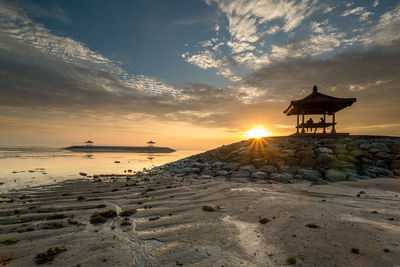 Scenic view of beach against sky during sunset