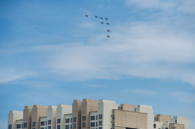 Aircrafts flying over buildings in city