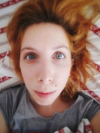 High angle portrait of girl lying on bed