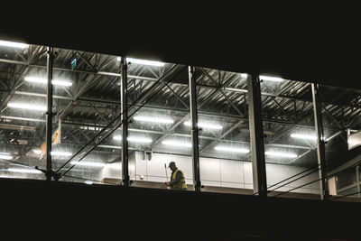 Rear view of man working at night