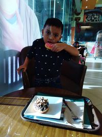 Portrait of a girl holding ice cream at home