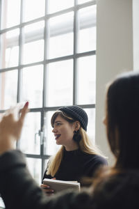 Female entrepreneur with box in creative office