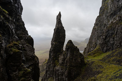 Rock formations on mountain against sky