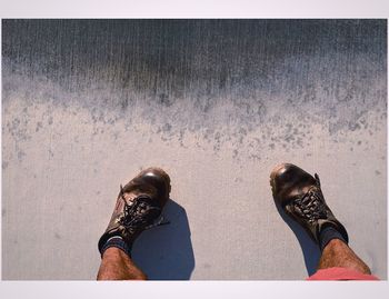 Low section of woman standing on tiled floor