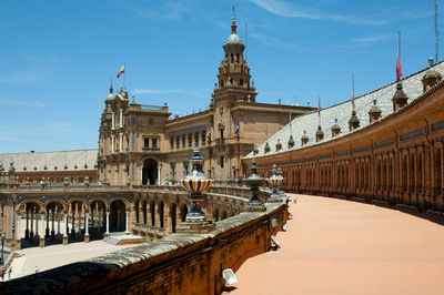 Footpath leading towards historic building against sky