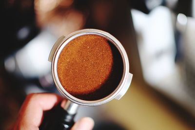 Close-up of hand holding coffee cup