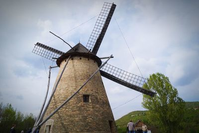 Low angle view of traditional windmill against sky