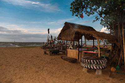 Lifeguard hut on beach against sky