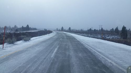 Road passing through city during winter