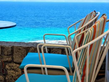 Swimming pool by sea against sky