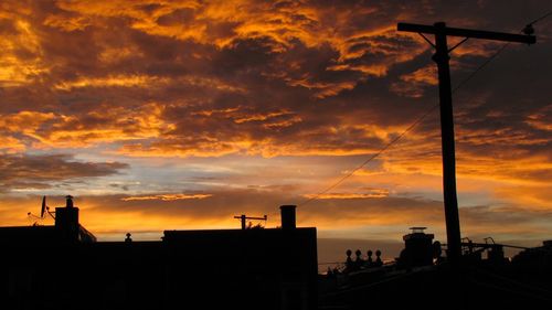 Silhouette of built structure against cloudy sky