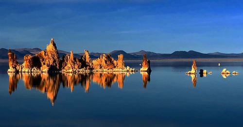 Rear view of man on lake against sky
