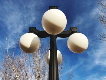 Low angle view of street light against blue sky