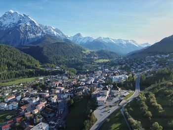 High angle view of townscape and mountains against sky