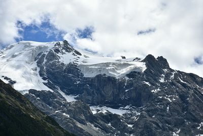 Scenic view of mountains against cloudy sky