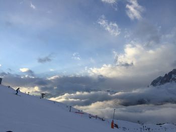 Low angle view of snowcapped mountains against sky