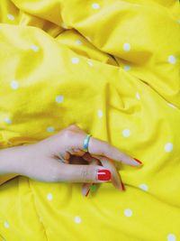 Close-up of woman hand with yellow leaf