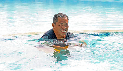 Portrait of man swimming in pool