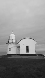 View of church by sea against sky