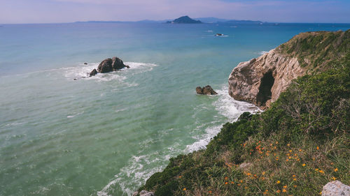 High angle view of rocks on sea against sky