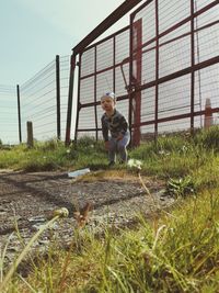 Full length of boy on field against sky