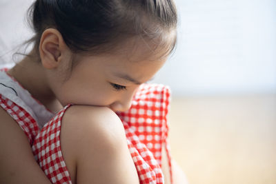 Close-up of cute girl looking down