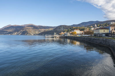 Extra wide angle view of the promenade on the lake in luino with the mountains in the background