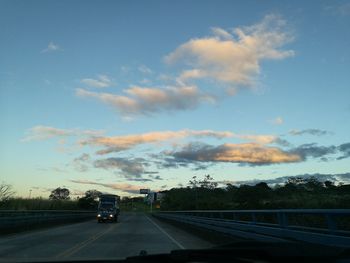 Cars on road against sky